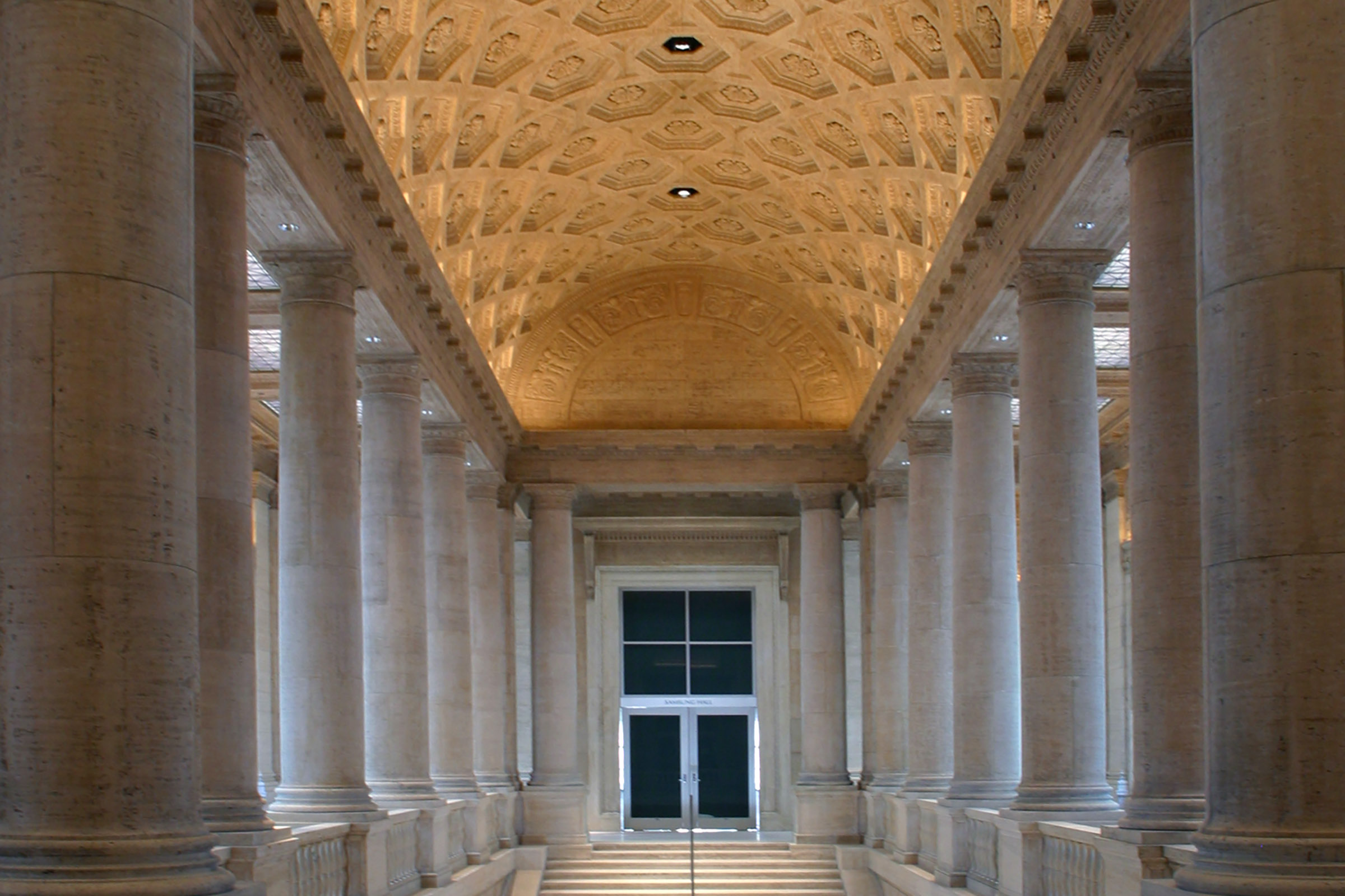 Image of stairs leading up to double doors, with an illuminated ornate ceiling overhead