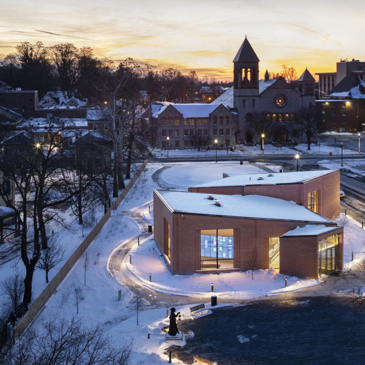 An aerial view of snow-covered buildings at dusk.
