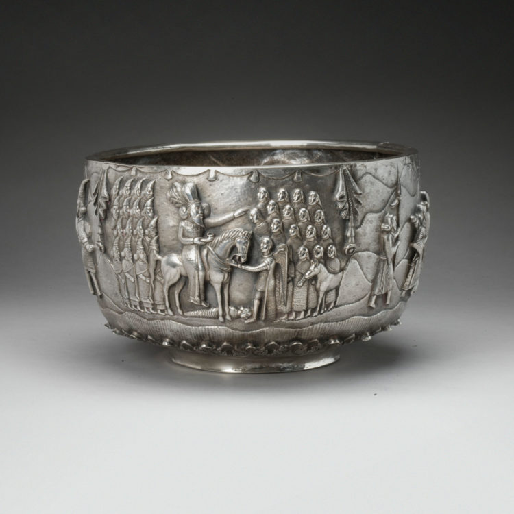 Silver bowl with scene of numerous human figures decorating the exterior.