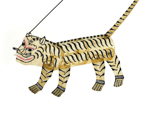 Small, semi-translucent puppet in the shape of a tiger. Light yellow with thin black stripes and a long, pointy tail.  