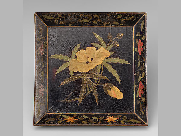 Square tray in black lacquer with painted design of yellow and red flowers.