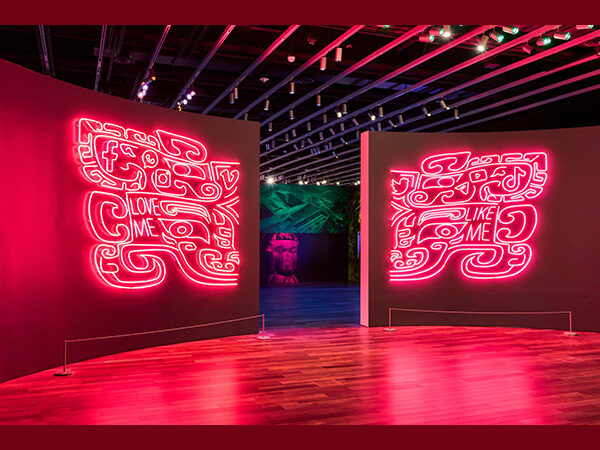 Pink neon artwork flanking a doorway.