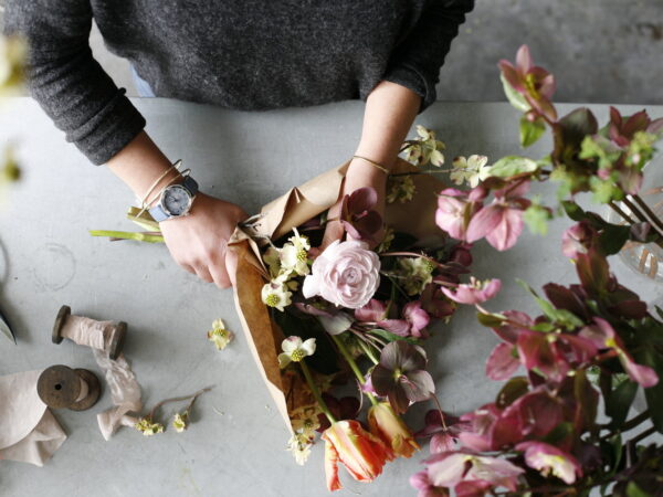 La Lavande floral artist arranging a bouquet of flowers.